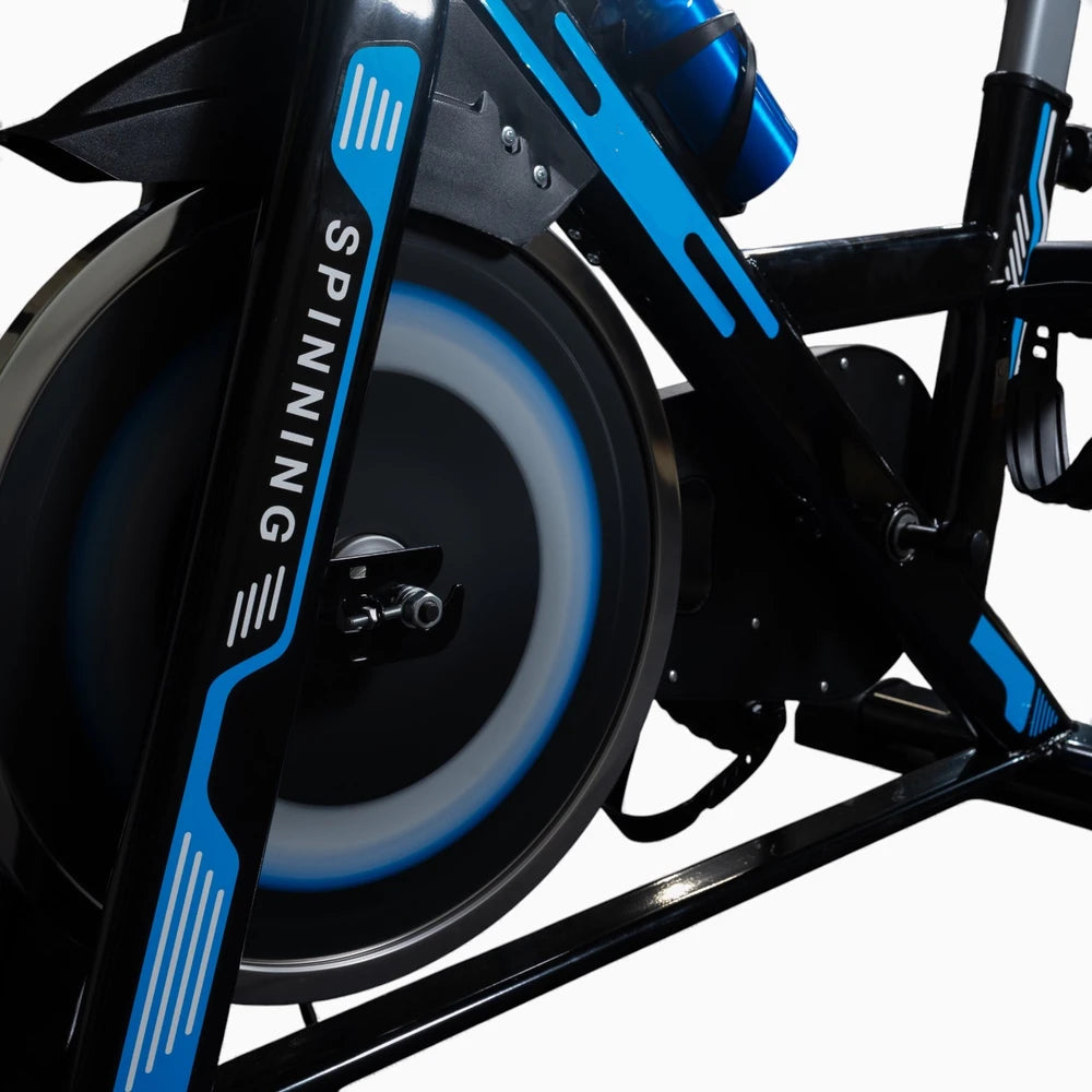Close-up of a spinning bike with blue and black design on a white background