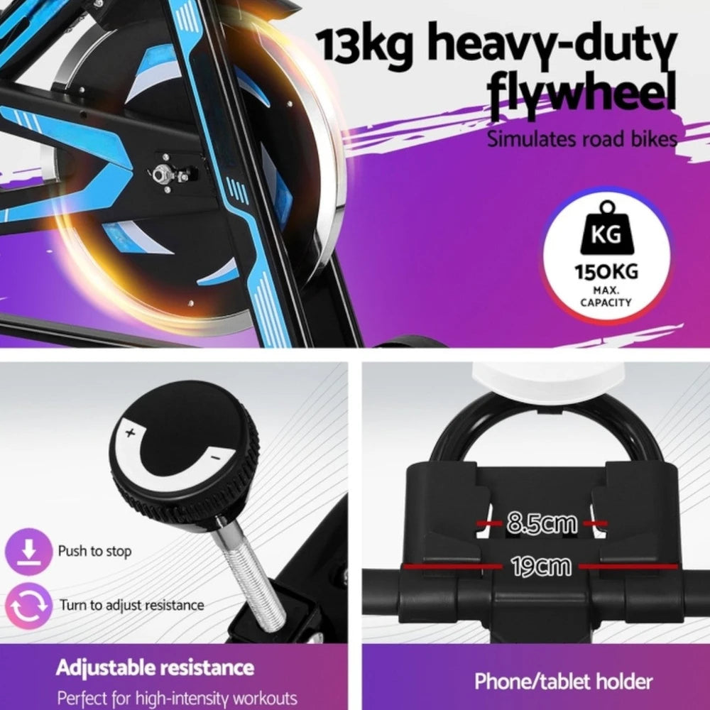 Fitness bike with 13kg heavy-duty flywheel, adjustable resistance, and phone/tablet holder on a purple background.