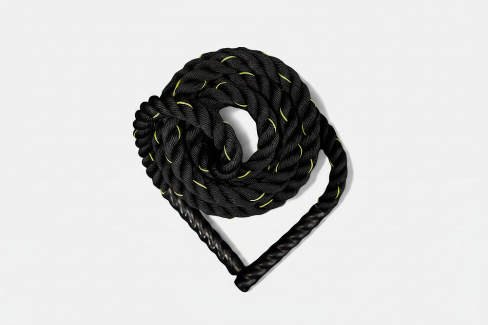 Coiled black battle rope with yellow accents on a white background