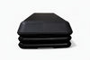 Black aerobics stepper with platform height adjusters on a white background