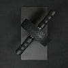 Black ab roller with textured handle on a black background