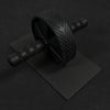 Ab roller and mat on a dark background