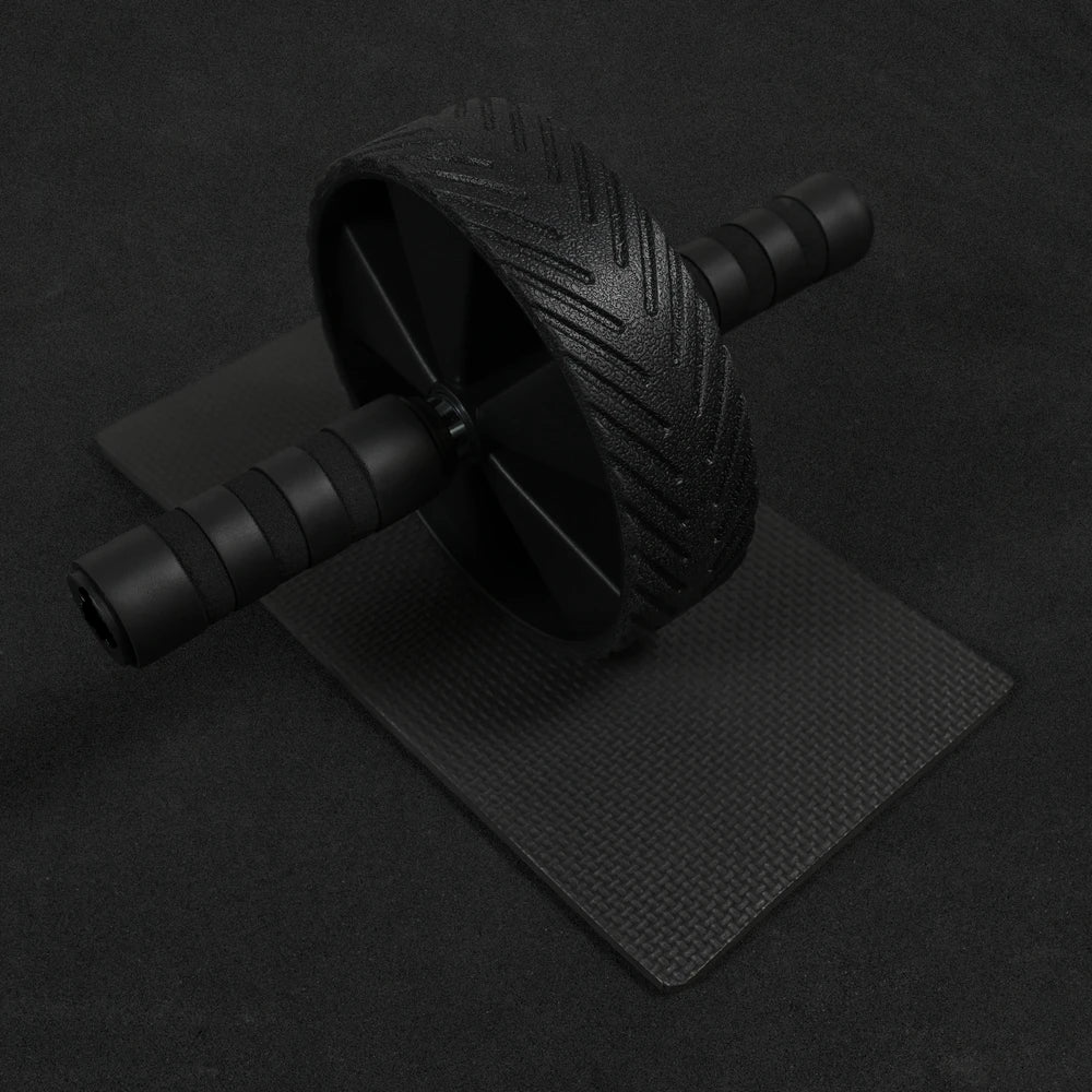 Ab roller and mat on a dark background