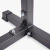 Close-up of a black strong metal frame corner with bolts on a white background