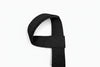 Black weight lifting wrist strap on a white background