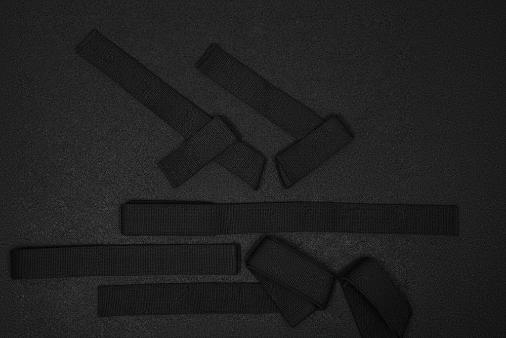 Black weight straps on a dark background