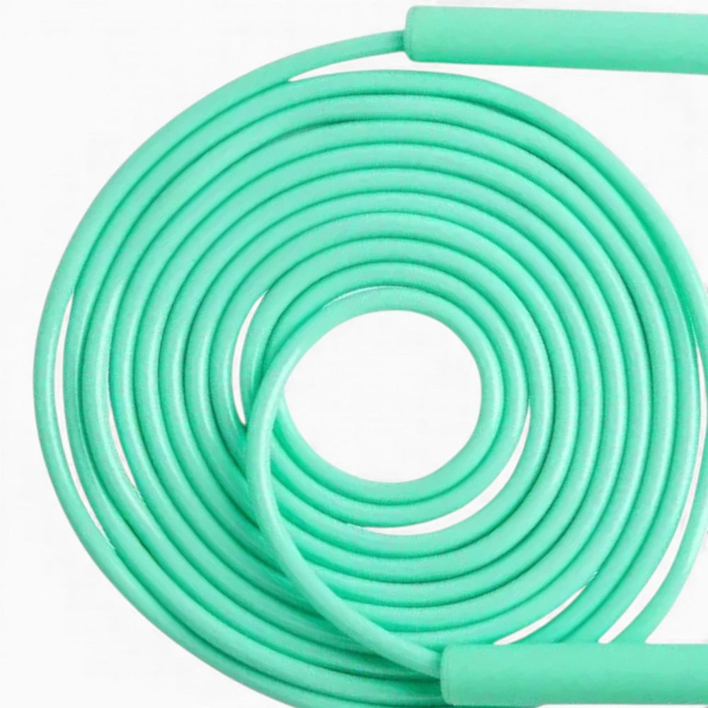 Coiled light green jump rope cable on a white background