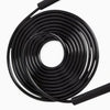 Coiled black jump rope cable on a white background