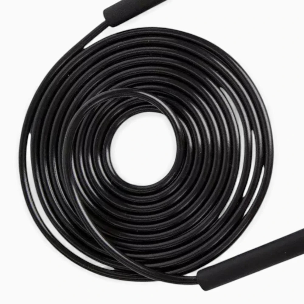 Coiled black jump rope cable on a white background