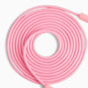 Pink coiled jump rope on a white background