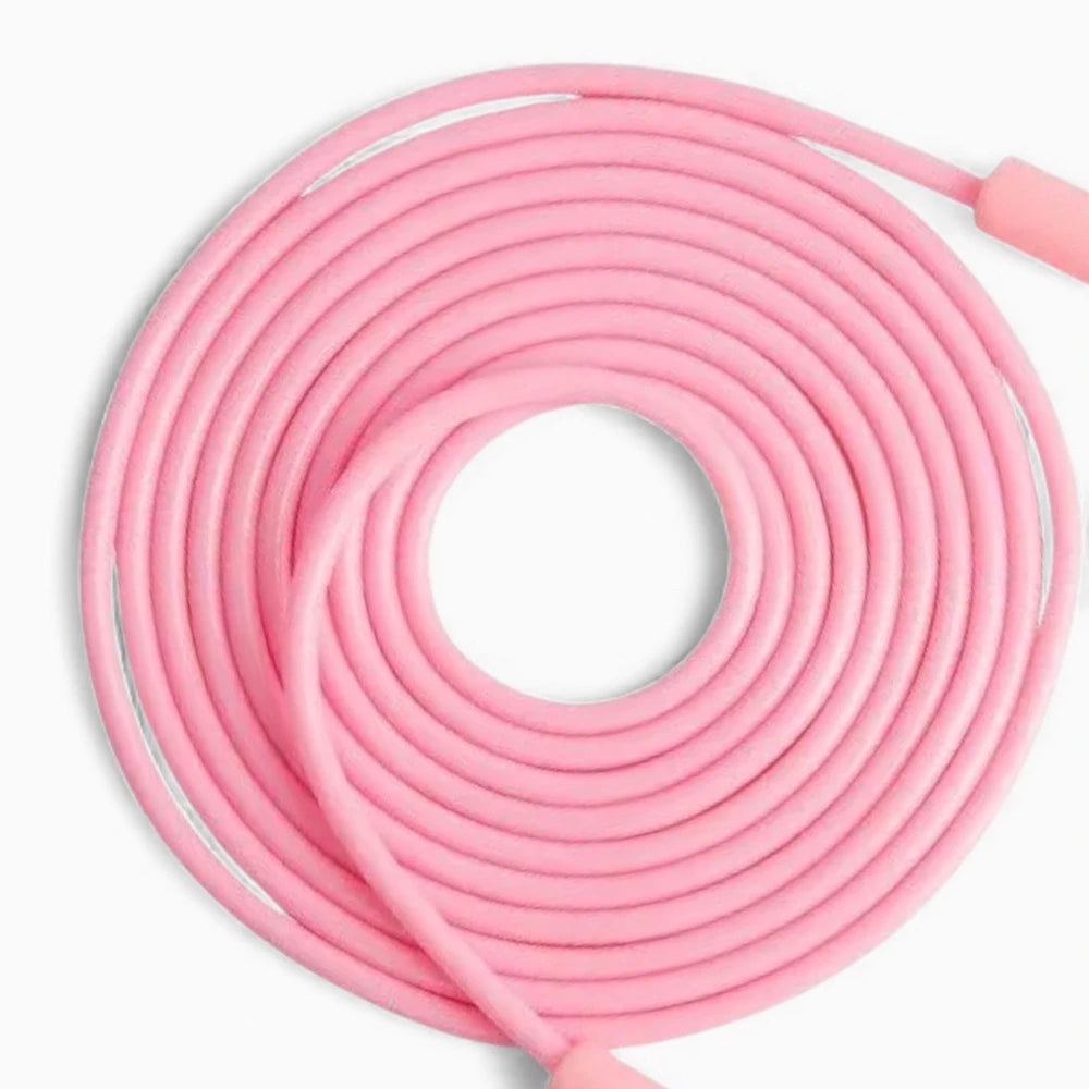 Pink coiled jump rope on a white background