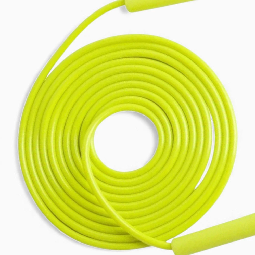 Coiled yellow jump rope cable on a white background