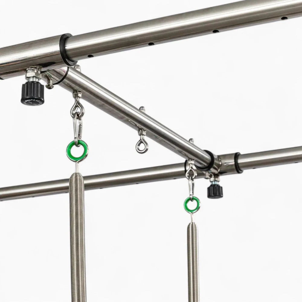 Metal hanging system with hooks and green rings on a white background
