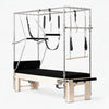 Essential cadillac pilates reformer machine with attachments on a white background