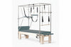 Pilates reformer machine with attachments on a white background