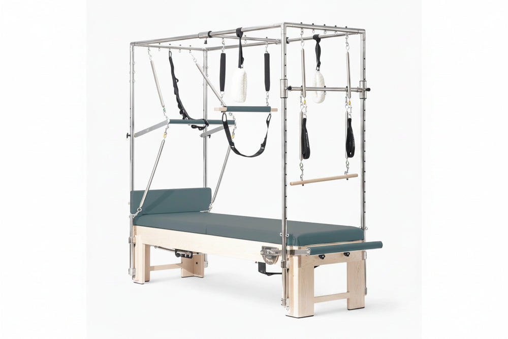 Pilates reformer machine with attachments on a white background