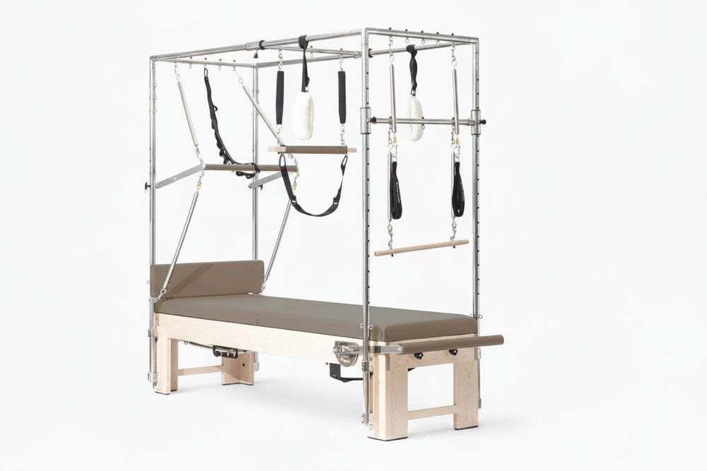 Pilates reformer machine with attachments on a white background