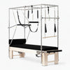 Pilates reformer machine with attachments on a white background