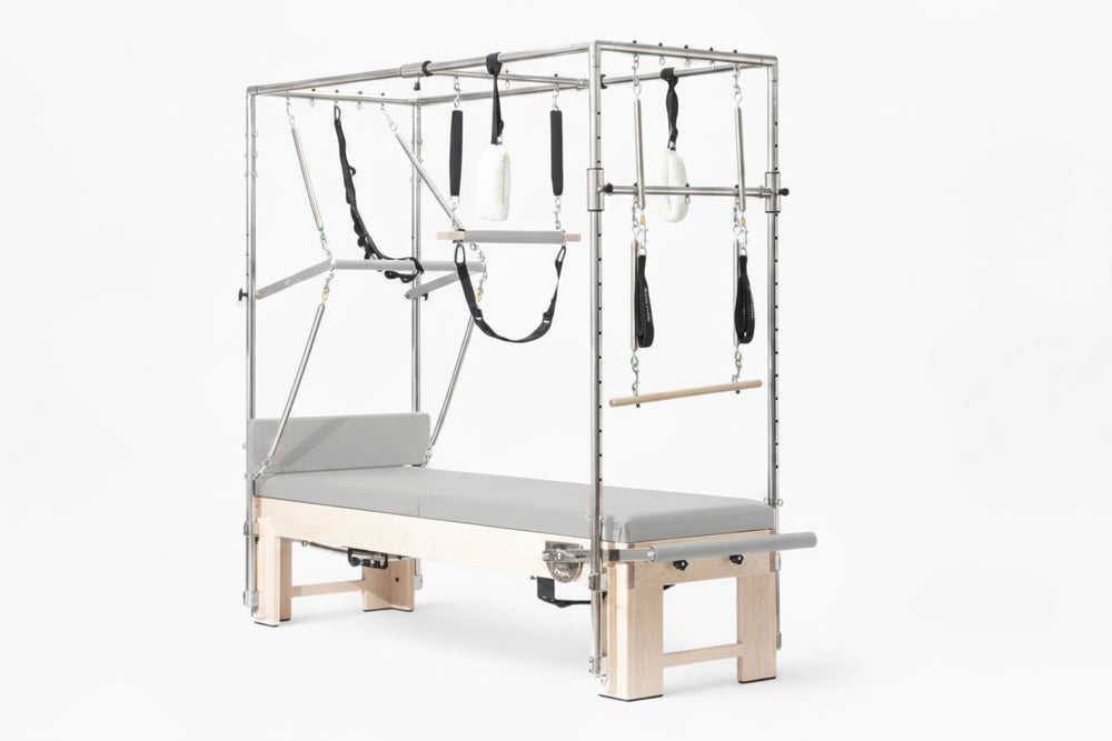 Pilates reformer machine with attachments on a white background