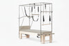 Pilates reformer machine with attachments on a white background