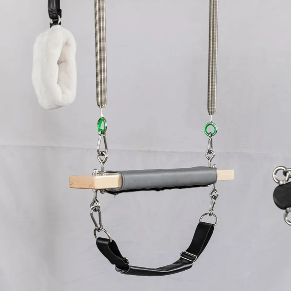 Essential cadillac pilates reformer attachments on a grey background