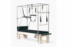 Pilates reformer machine with attachments on a white background