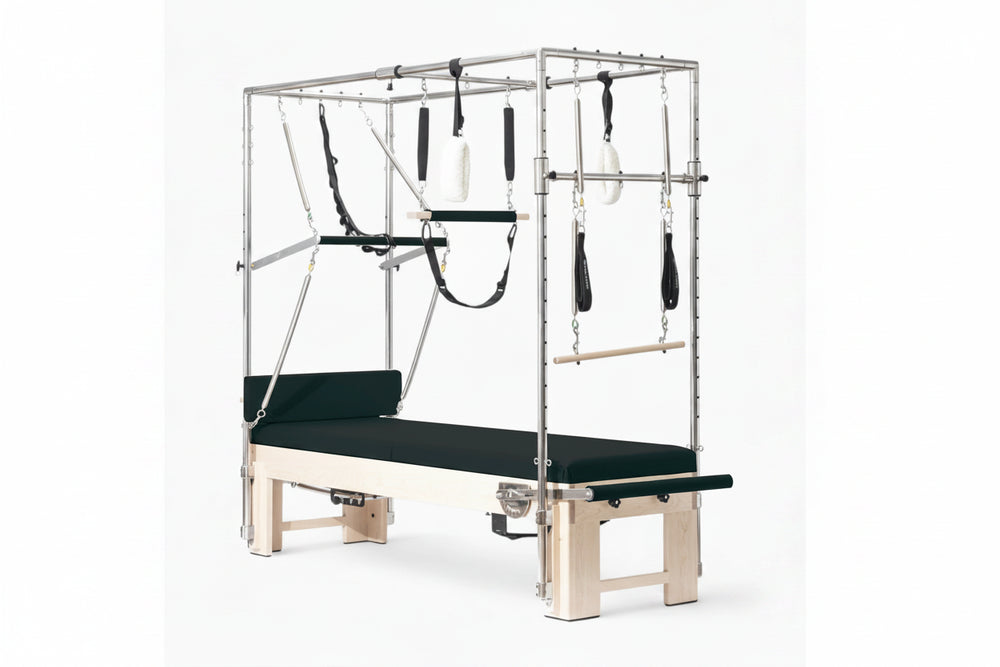 Pilates reformer machine with attachments on a white background
