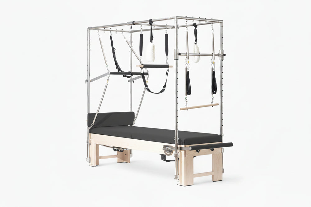 Pilates reformer machine with attachments on a white background