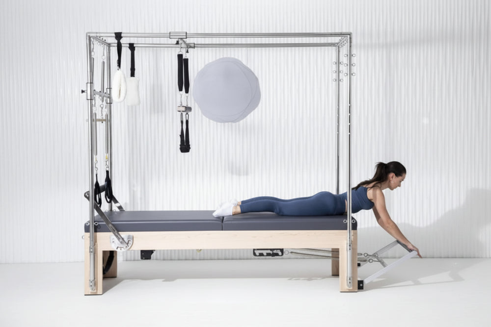 Woman using a pilates reformer machine in a studio setting