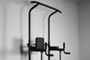 Black pull-up bar and workout station on a gray background