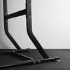 Black metal frame on a gray floor with a white wall background