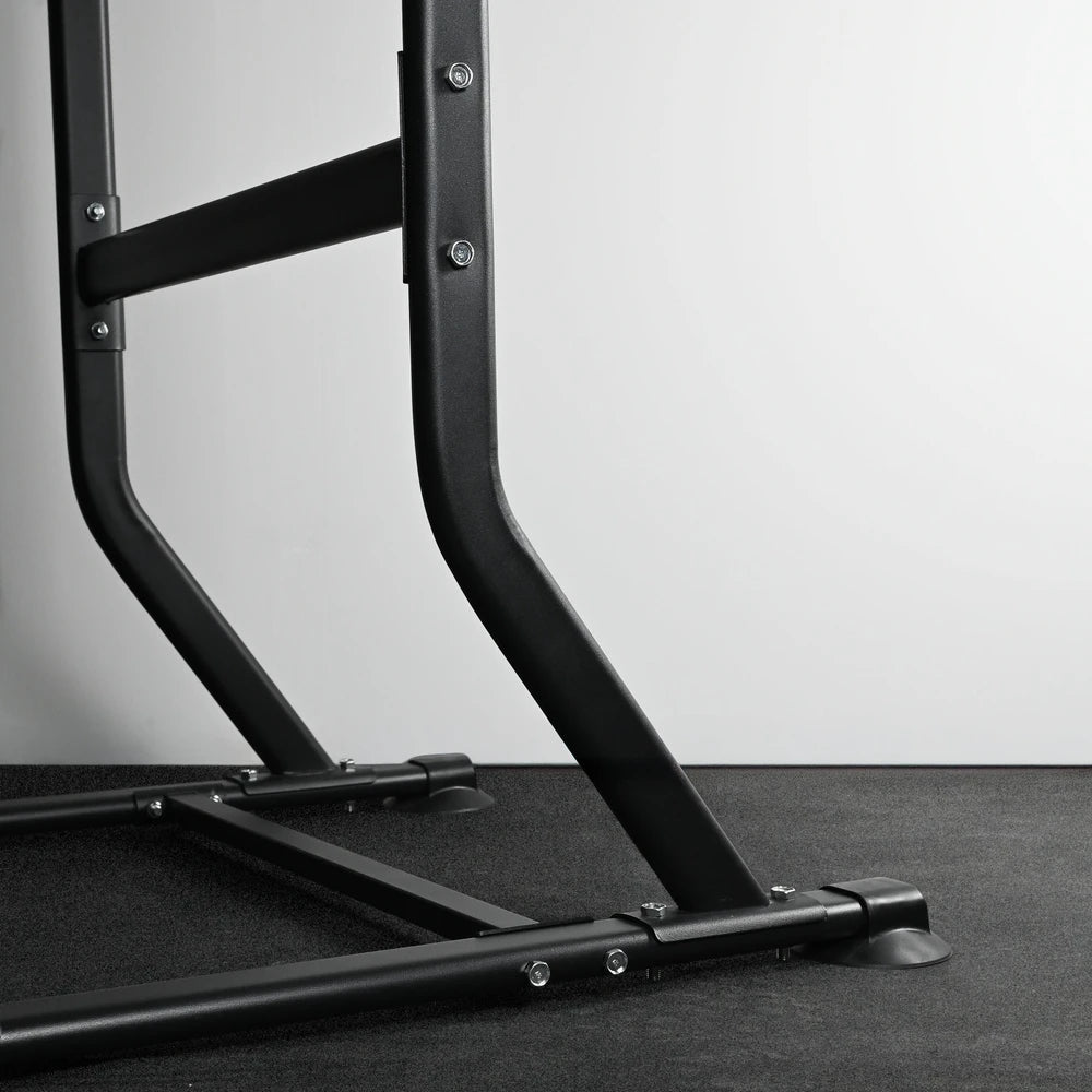 Black metal frame on a gray floor with a white wall background