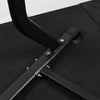 Black metal stand of pull up dip bar machine on a black surface with a white background