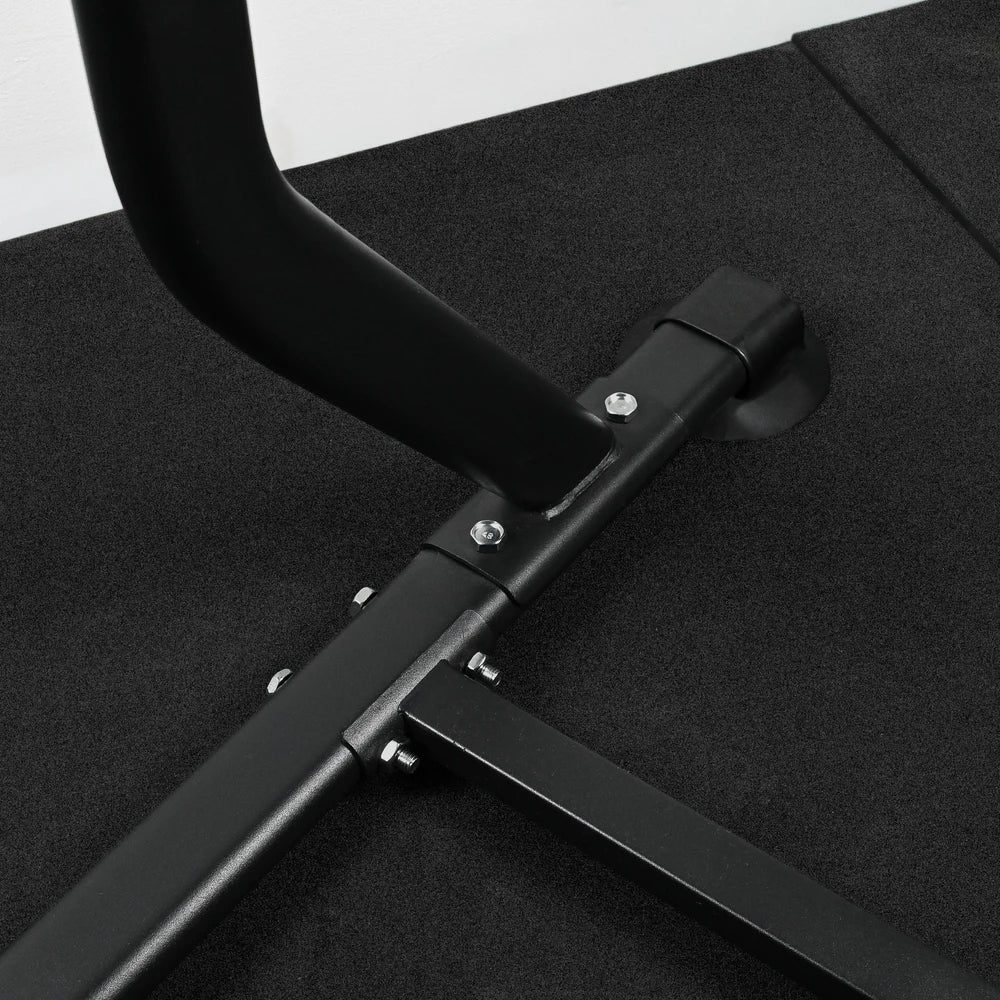 Black metal stand of pull up dip bar machine on a black surface with a white background