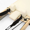 Mechanism of pilates reformer machine with cream coloured seats