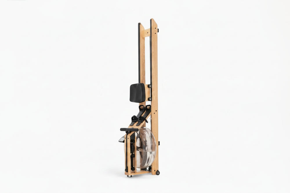 Folded rowing machine with wooden frame and black components on a white background