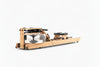 Wooden rowing machine with transparent water tank on a white background
