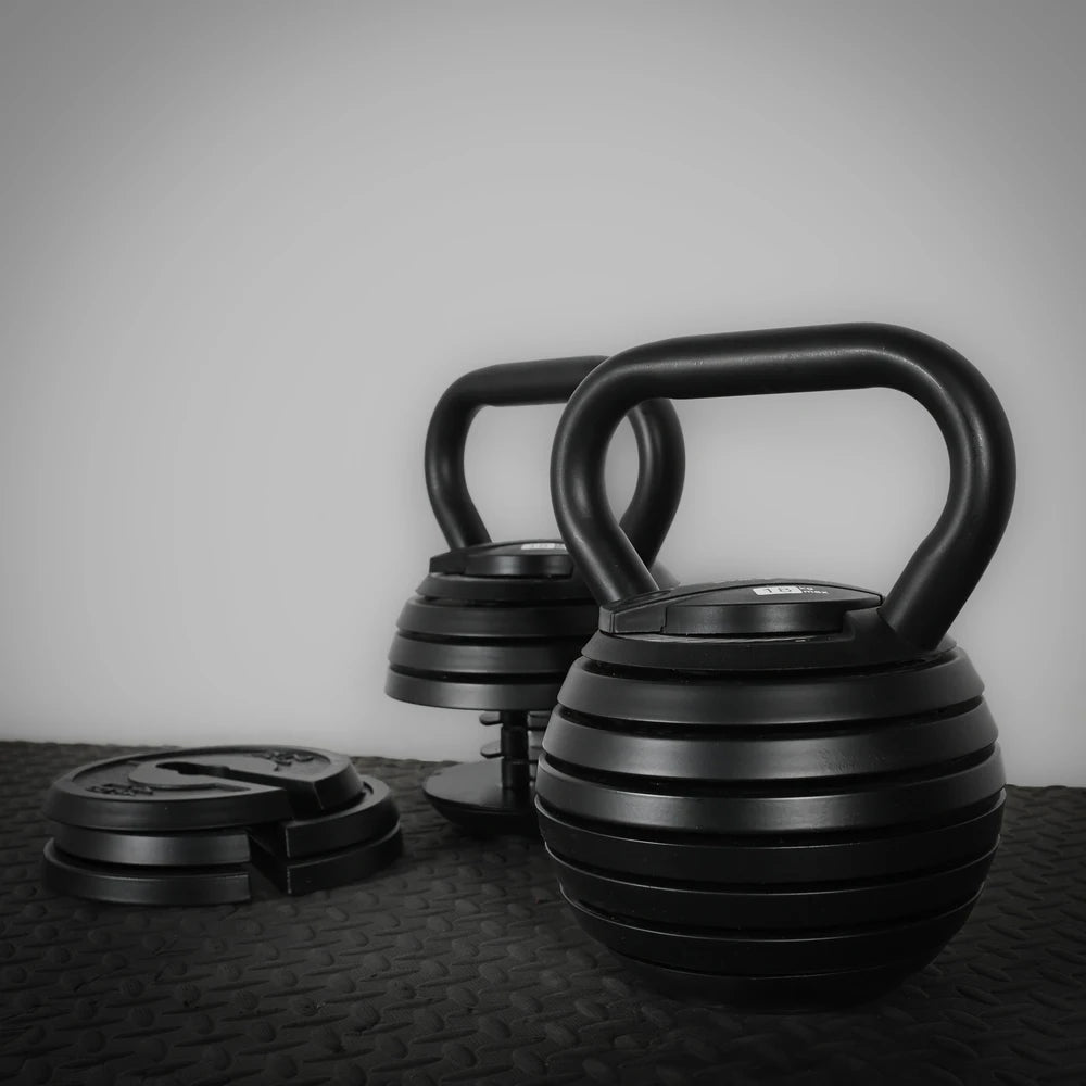 Weight plates from an adjustable kettlebell on a dark background