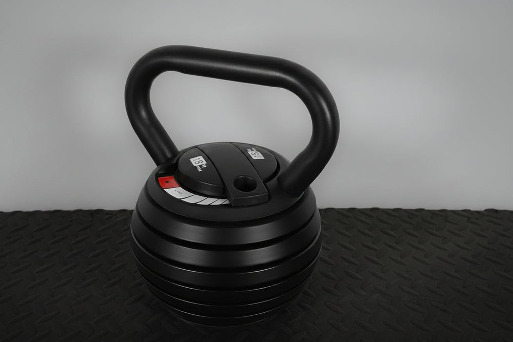 Black adjustable kettlebell on a textured floor