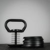 Adjustable plate weights from a kettlebell on a dark background