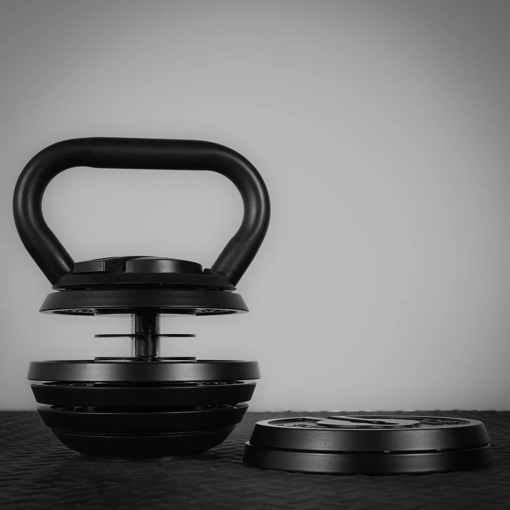 Adjustable kettlebell with 2 plates removed on a dark background