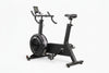 Black exercise bike with digital display on a white background