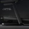 Black treadmill with incline/decline settings on a dark background