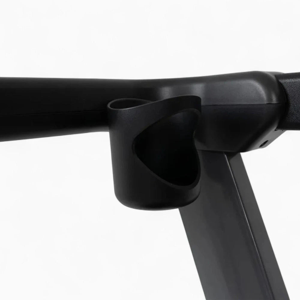 Close-up of a black metal bar with a cup holder on a white background