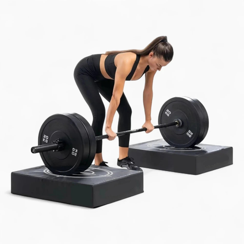 Woman lifting a barbell with weights on a white background