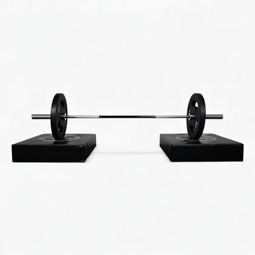 Barbell on weight pads against a white background