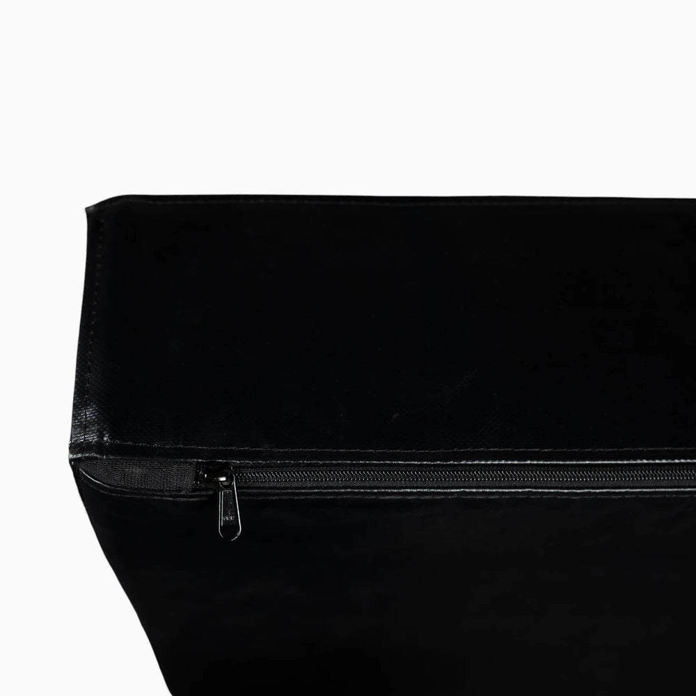 Close-up of a black weight drop pad with a zipper on a white background