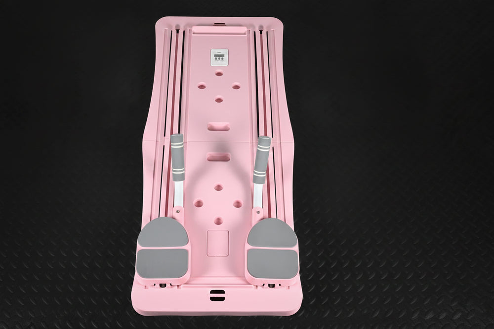 Pink and gray pilates reformer board on a black textured background