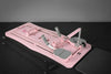 Pink pilates reformer bed on a dark floor