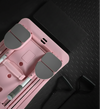 Pilates reformer board in pink on a dark floor